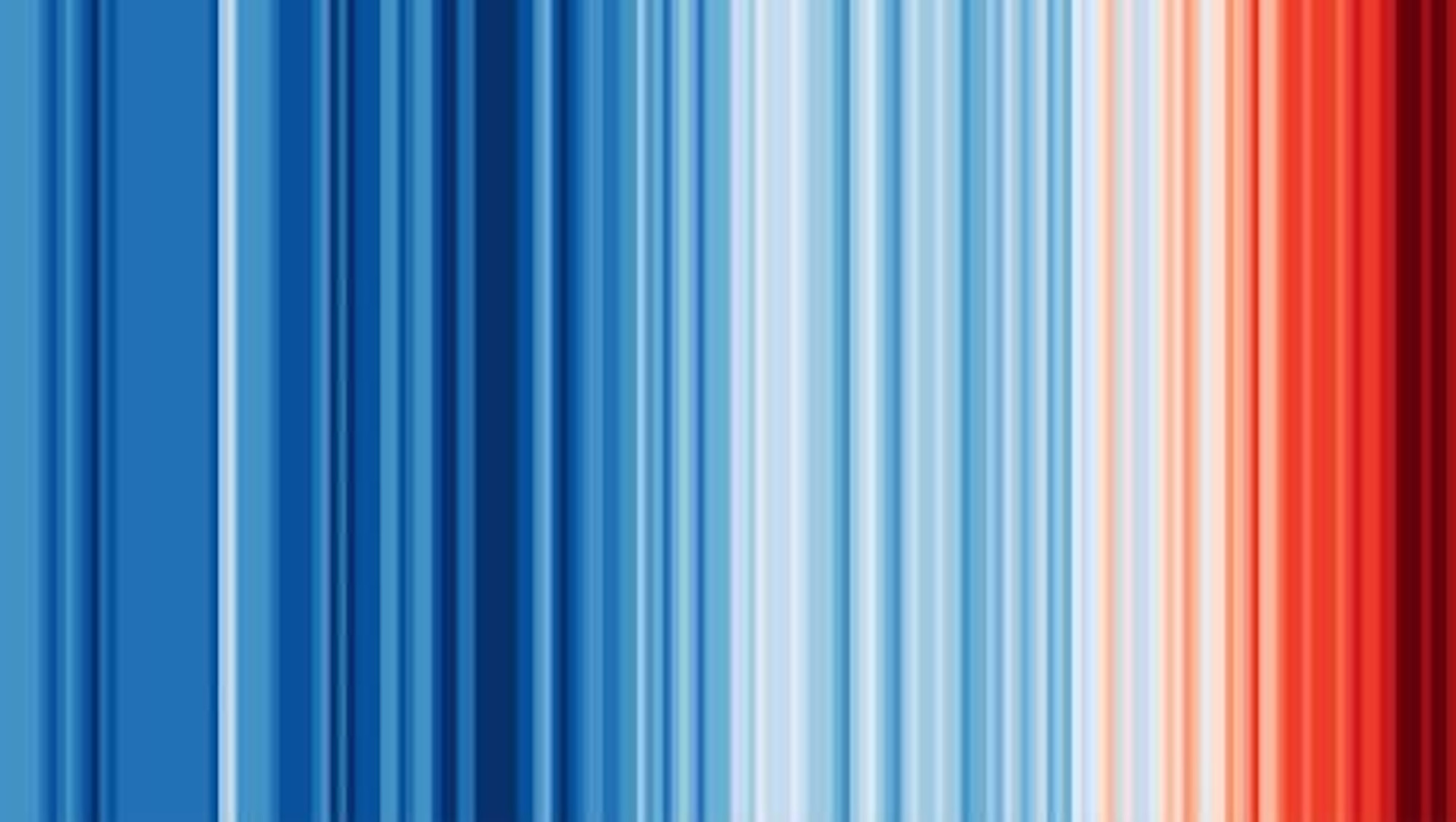 Ed Hawkins's climate stripes visualization — a series of vertical stripes shifting from cool blues to deep reds, representing the change in average global temperature year over year since 1850.
